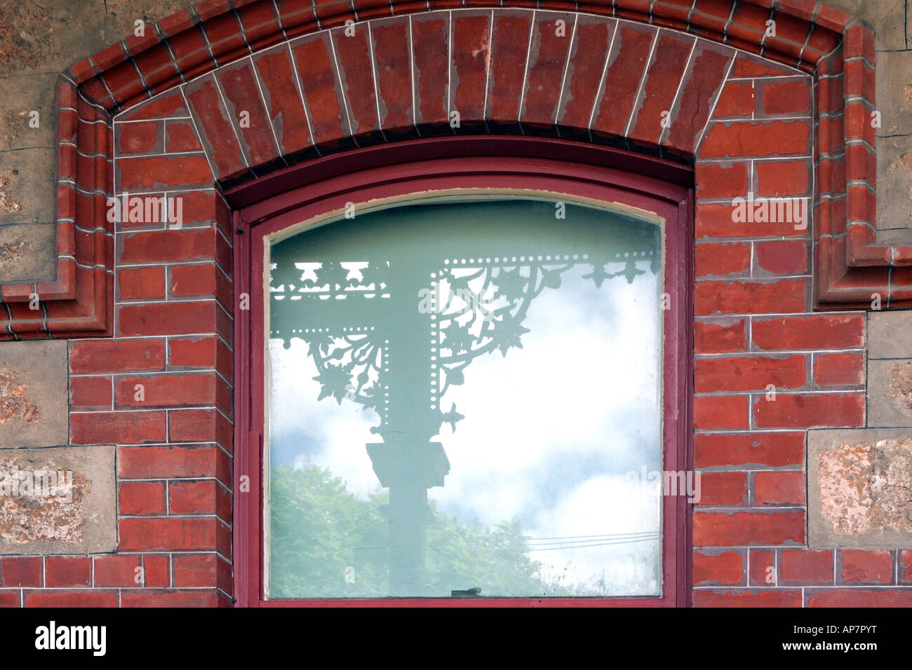 Brick decorated window reflecting wrought iron design of the house