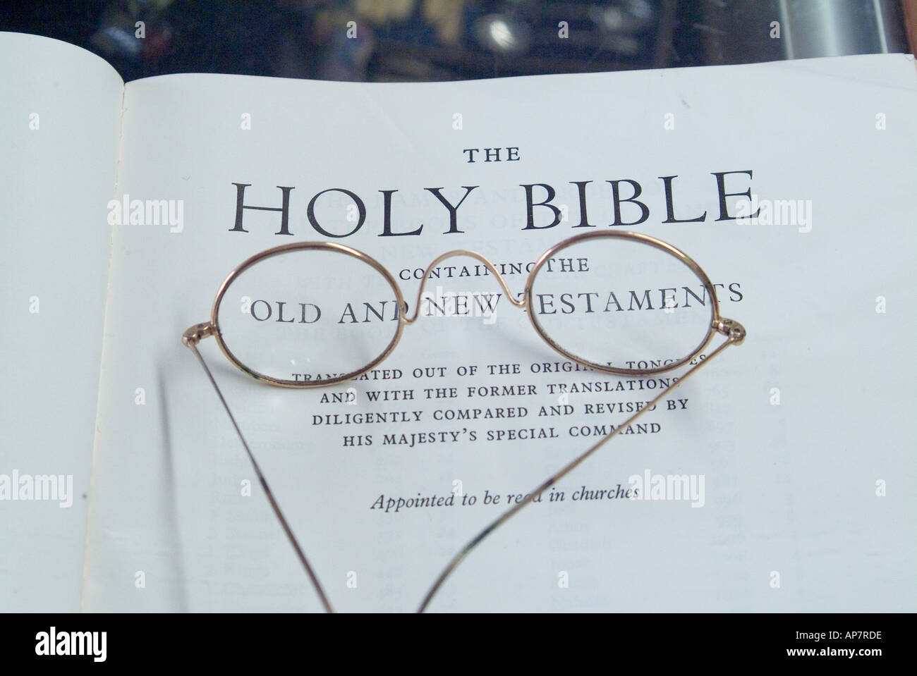 Pair of gold rimmed spectacles on the title page of an old bible Stock Photo