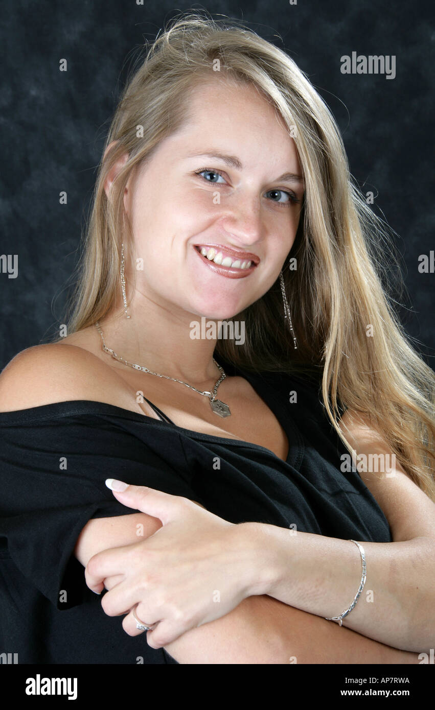Portrait of a Young Girl With Long Blonde Hair Wearing a Black Dress Stock Photo