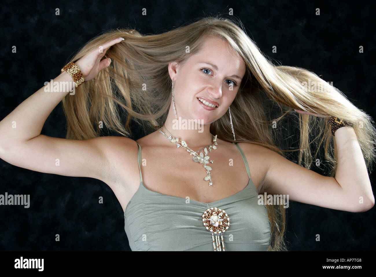 Portrait of a Young Girl Holding Her Long Blonde Hair Stock Photo