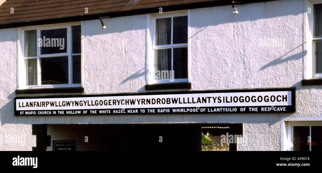 Sign displaying the full name of Llanfairpwllgwyngyllgogerychwyrndrobwllllantysiliogogogoch, a Welsh village with an incredibly long name.