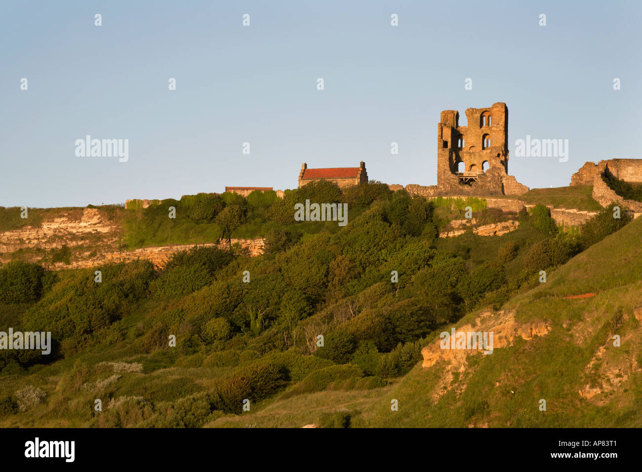 The Ruin of Scarborough Castle at Sunset from North Bay Scarborough North Yorkshire England Stock Photo
