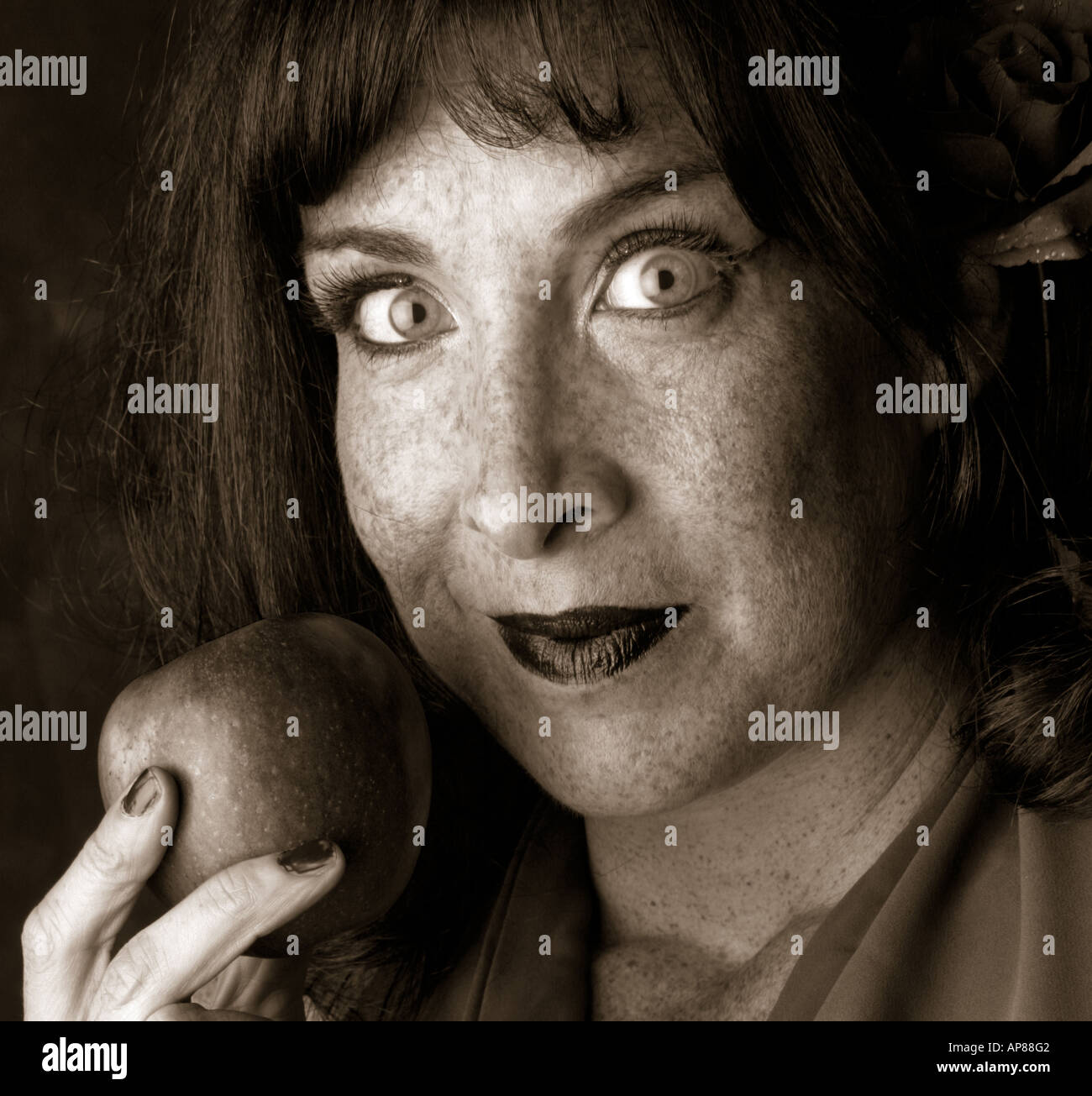 Burlesque Performer and Stage Entertainer Lilith De Paradis Eating an Apple Stock Photo
