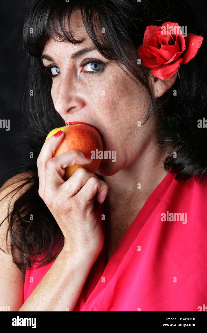 Burlesque Performer and Stage Entertainer Lilith De Paradis Eating an Apple Stock Photo