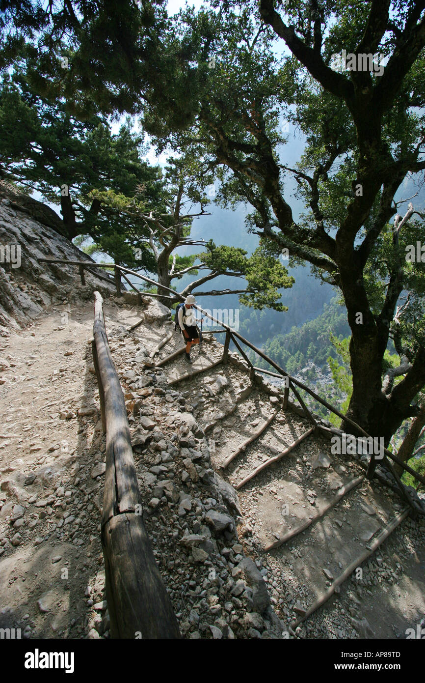 Young woman descending the steep Xyloskali path down into the Samaria Gorge South Western Crete Stock Photo