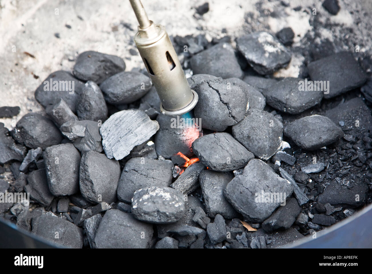 Lightning the charcoal with a gas burner Stock Photo Alamy