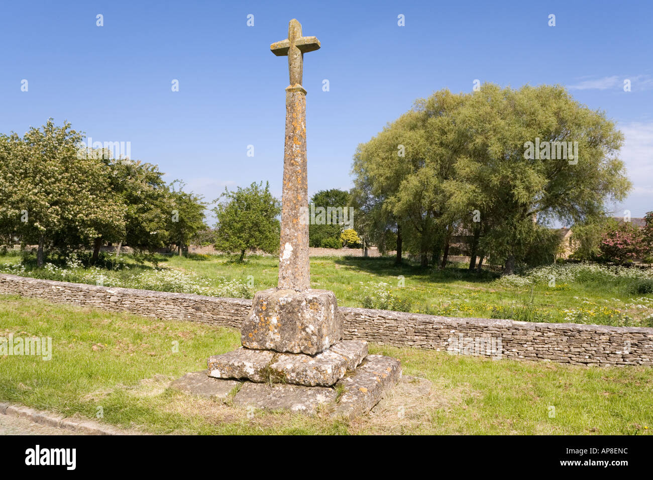 Restored 14th Century wayside preaching cross in the Cotswold village ...