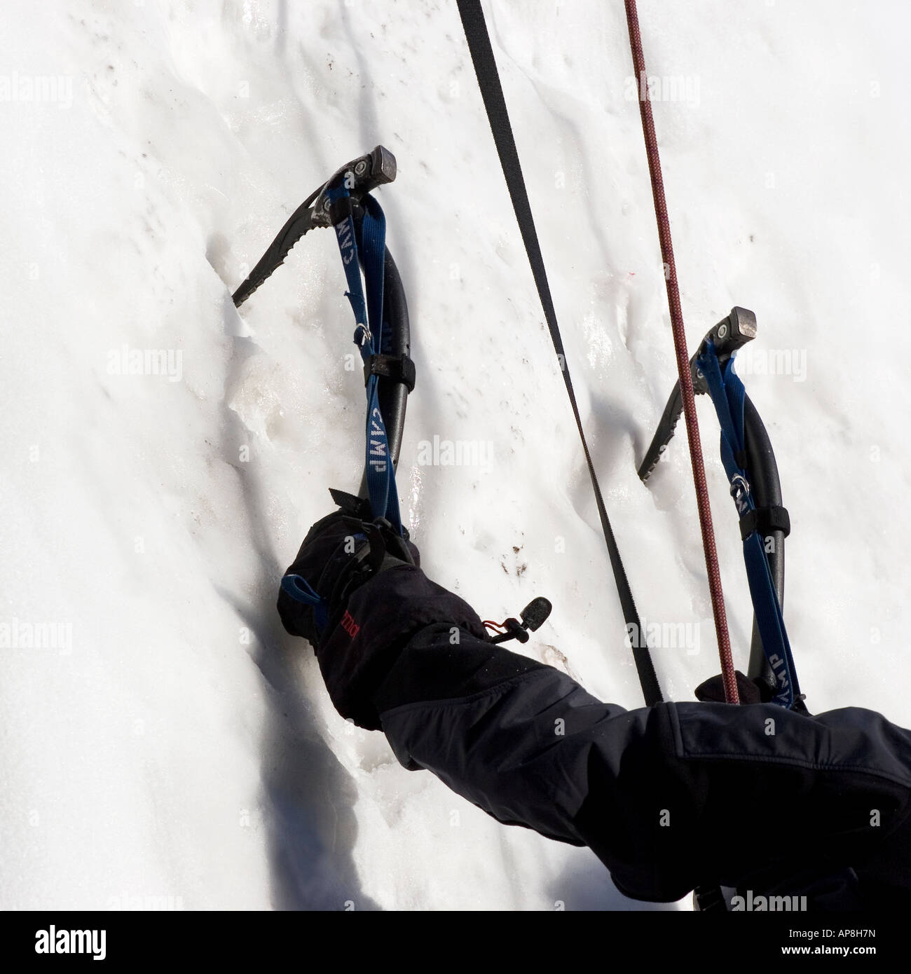 Climber climbing a wall of ice and snow Stock Photo