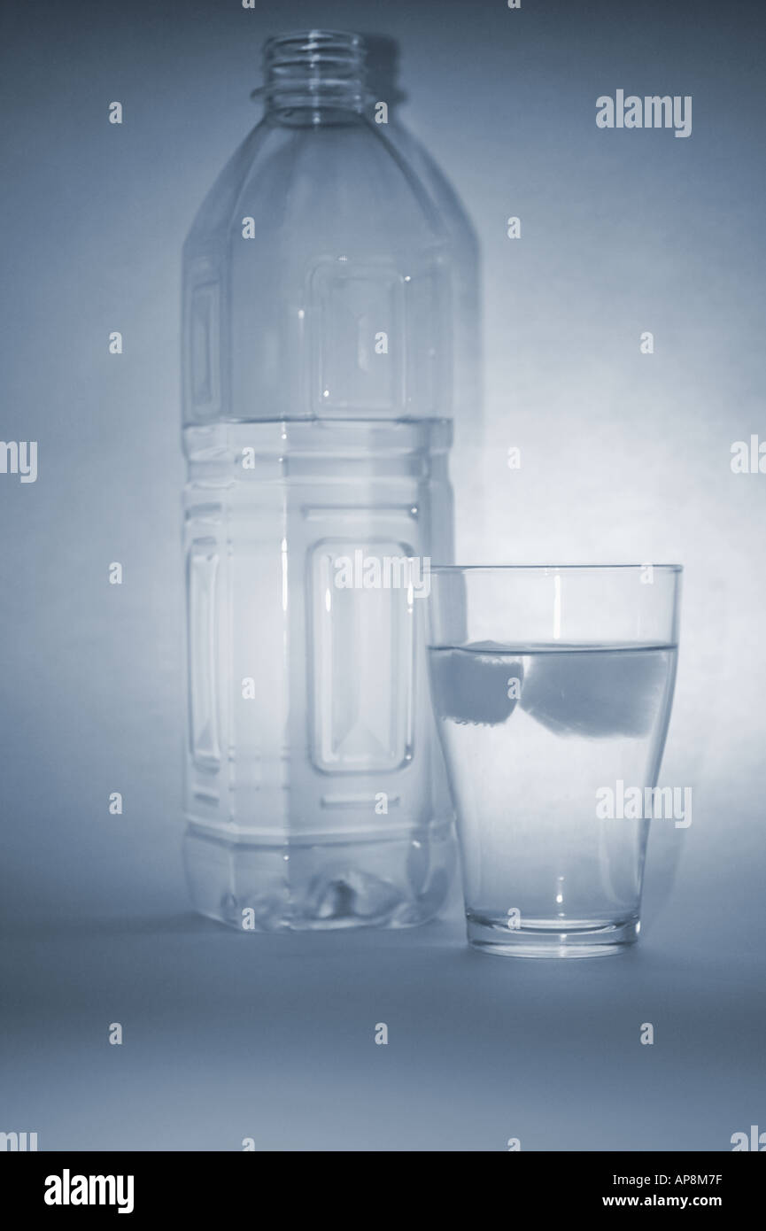 a glass and bottle of refreshing mineral water with ice cubes Stock ...