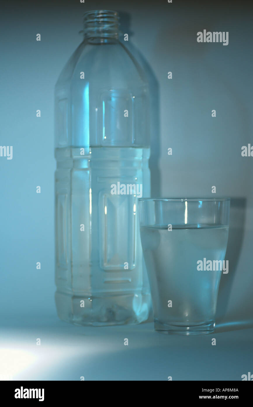 a glass and bottle of refreshing mineral water with ice cubes Stock ...