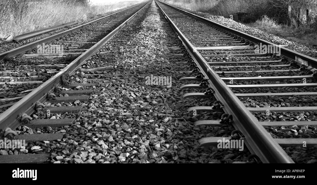 Parallel lines: railway track disappears into the horizon Stock Photo