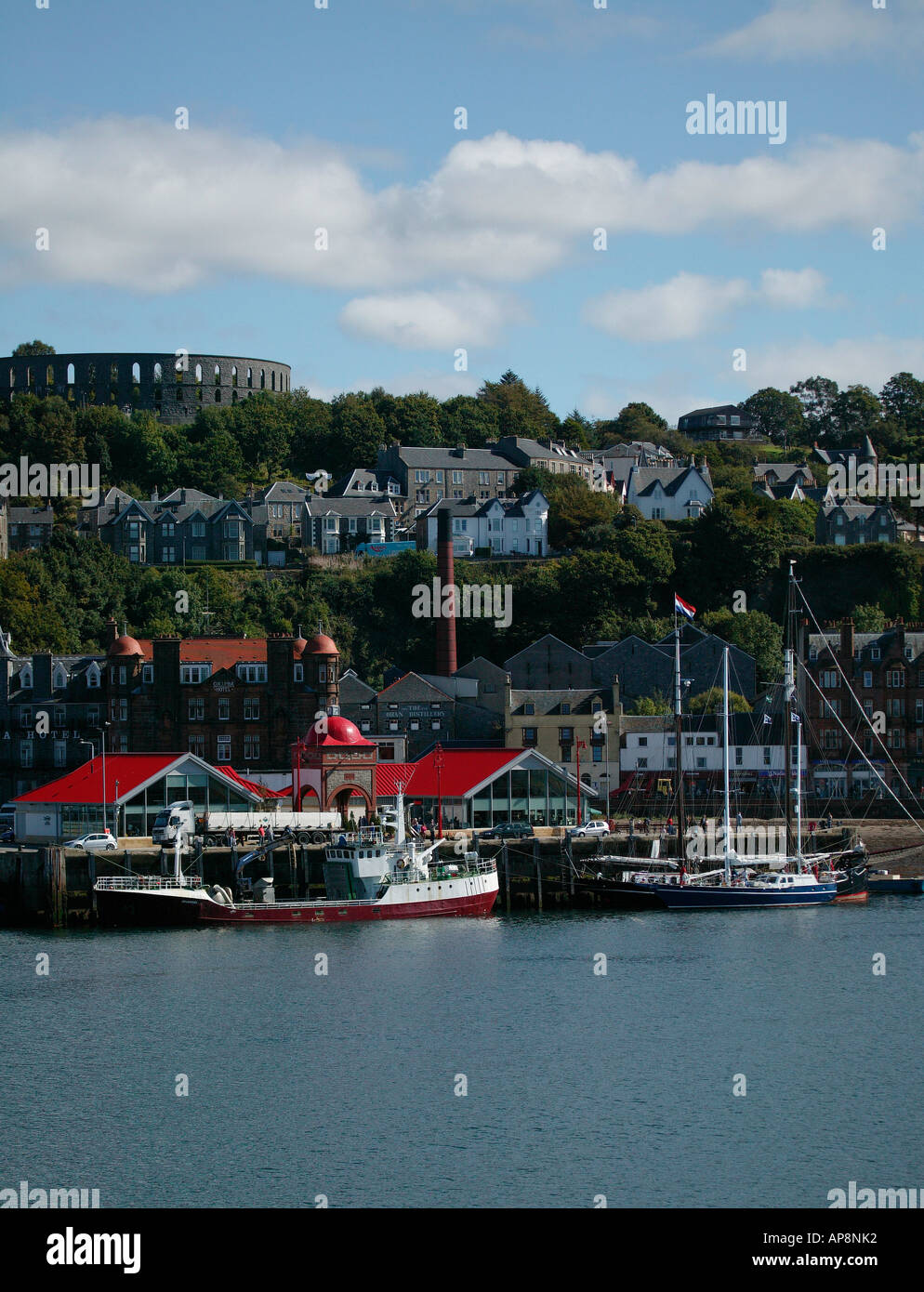 Oban Harbour pier and Macaig Tower in background  viewed from Caledonian Macbrayne ferry, Scotland Stock Photo