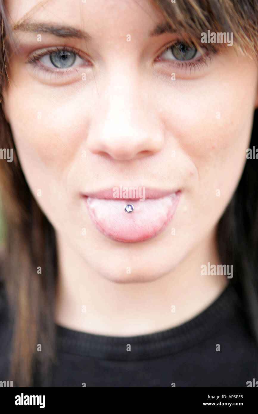 YOUNG WOMAN STICKING HER TONGUE OUT Stock Photo