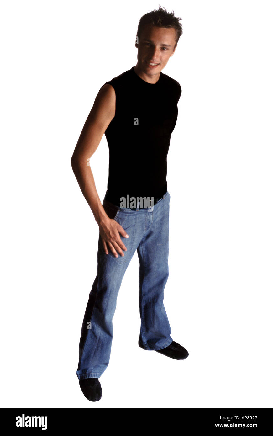 young man with jeans and black t shirt stand up looking camera on blank background Stock Photo