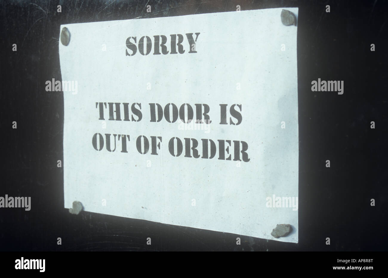 Sign printed on paper and stuck to inside of window stating Sorry This door is out of order Stock Photo