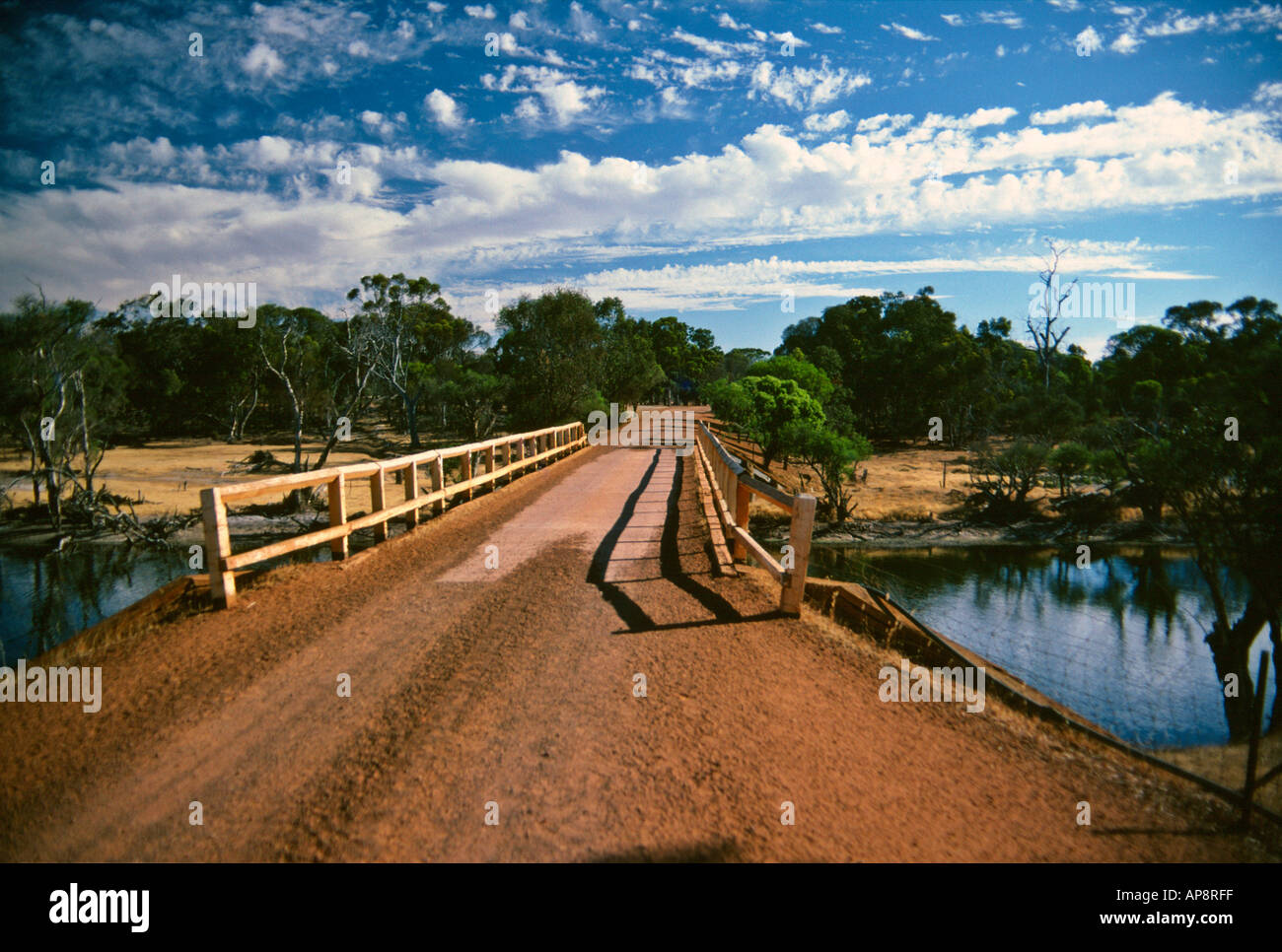 Gravel road over bridge through wheatbelt farmland near Katanning Western Australia Stock Photo