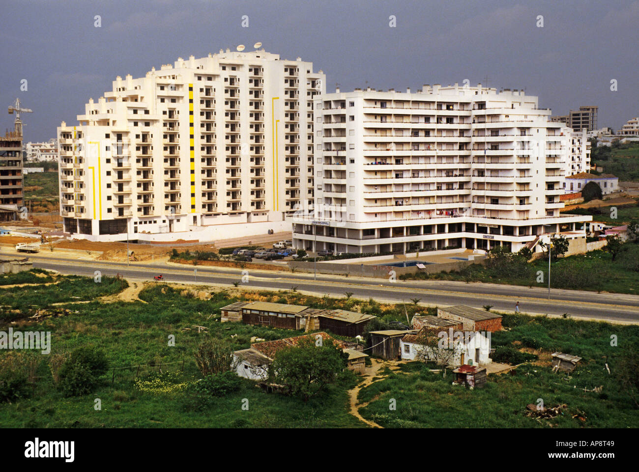 New hotels and apartments opposite old houses Praia da Rocha Algarve Portugal Europe Stock Photo