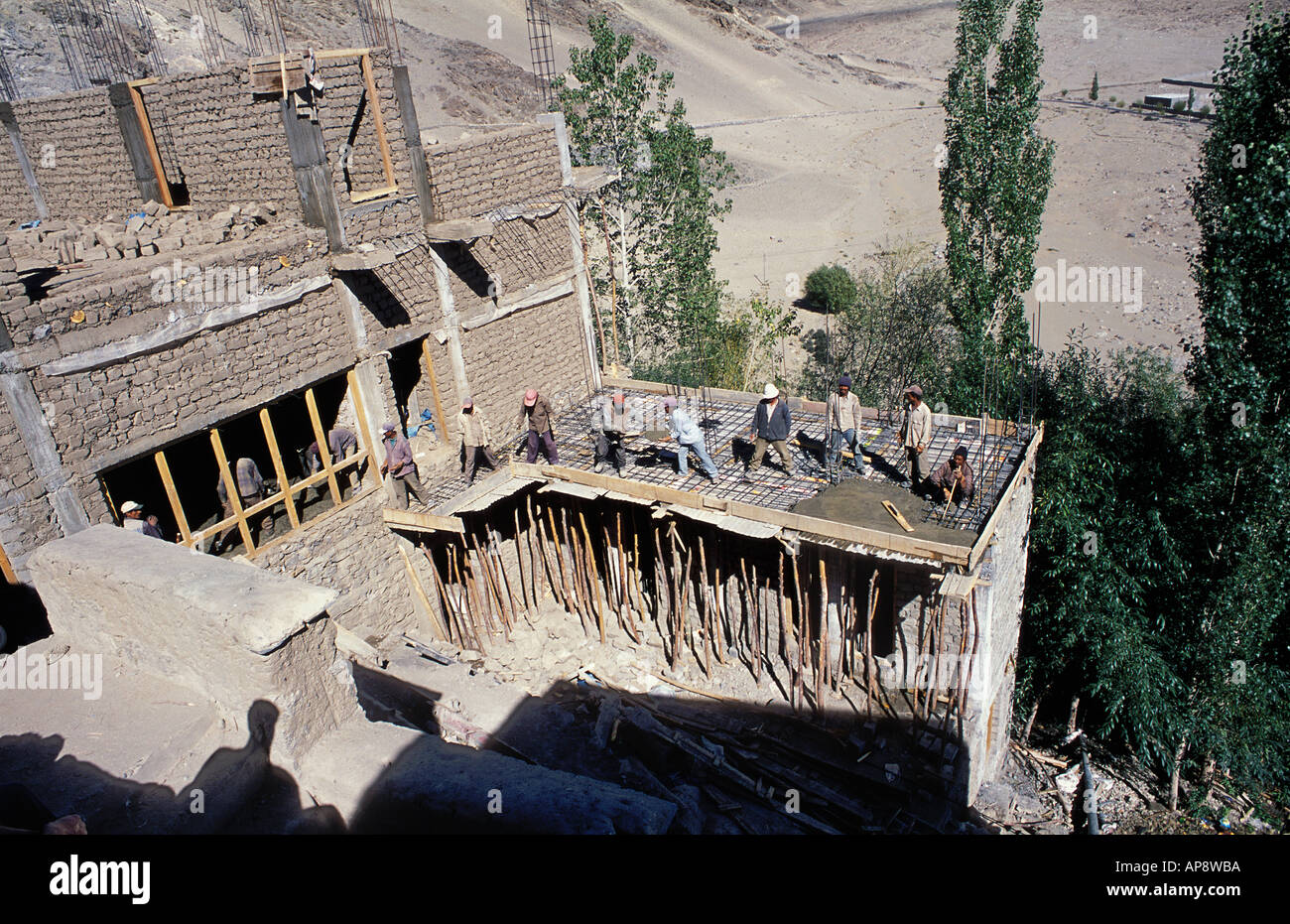 Manual labour laying concrete Thikse Ladakh India Stock Photo