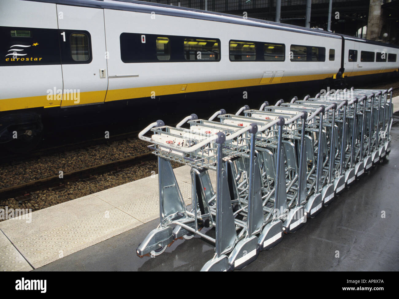 Paris Gare du Nord high speed Eurostar train in the station and luggage trolleys lined up on the