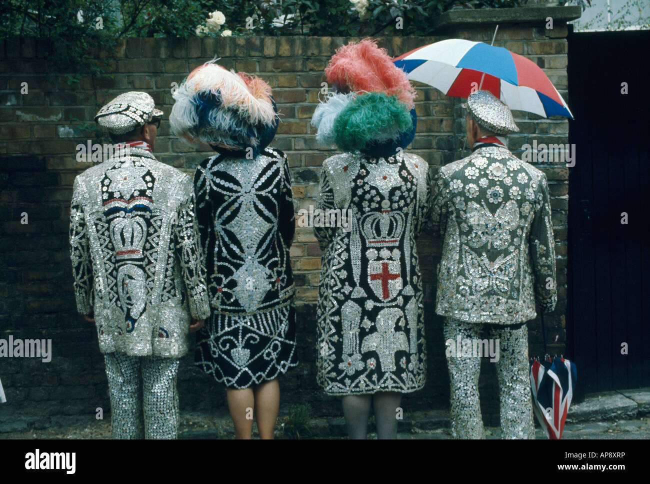 Pearly kings and queens showing the backs of their coats Stock Photo