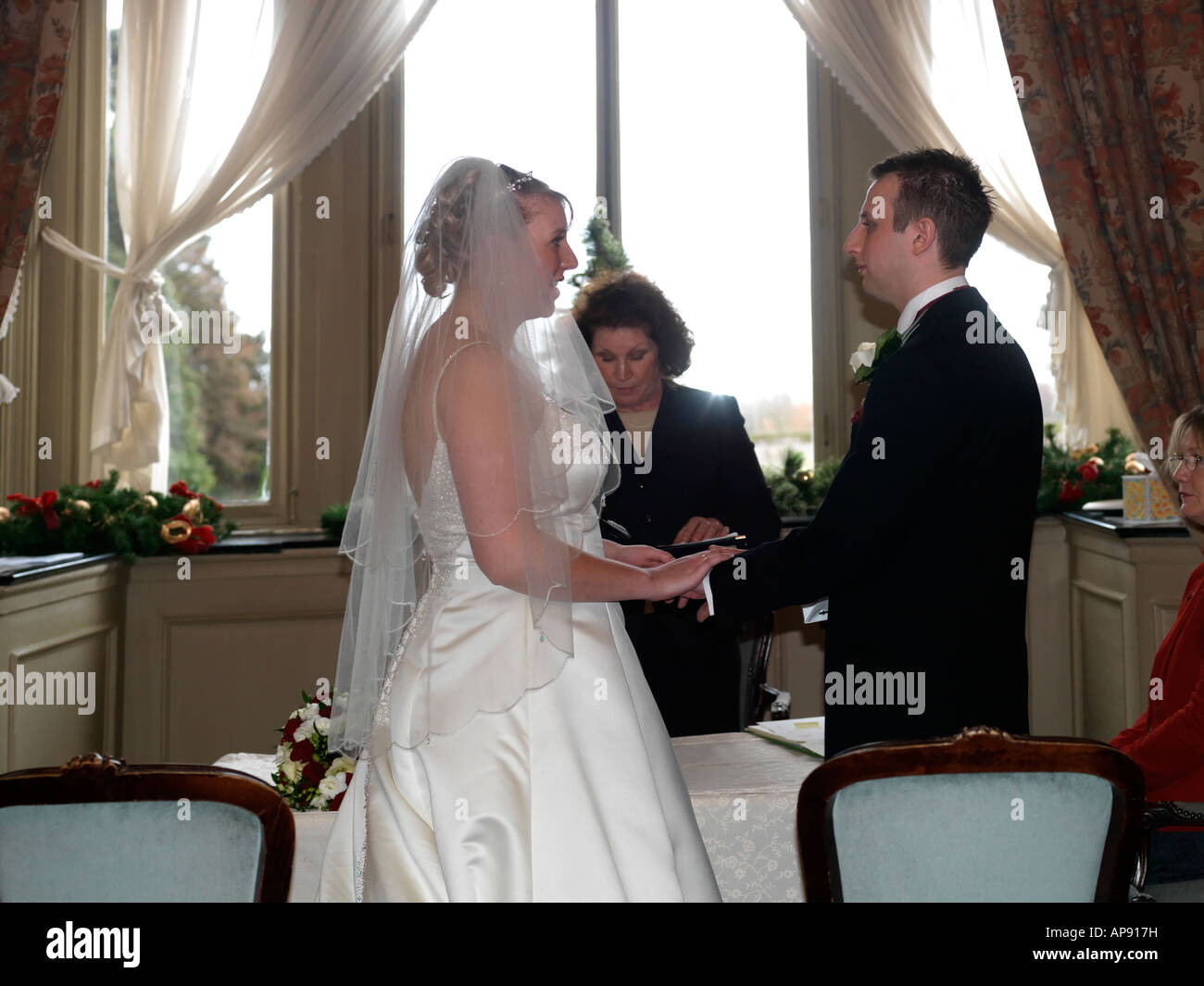 Bride and Groom Exchanging Vows at Christmas Wedding Thorpe Hall Peterborough England Stock Photo