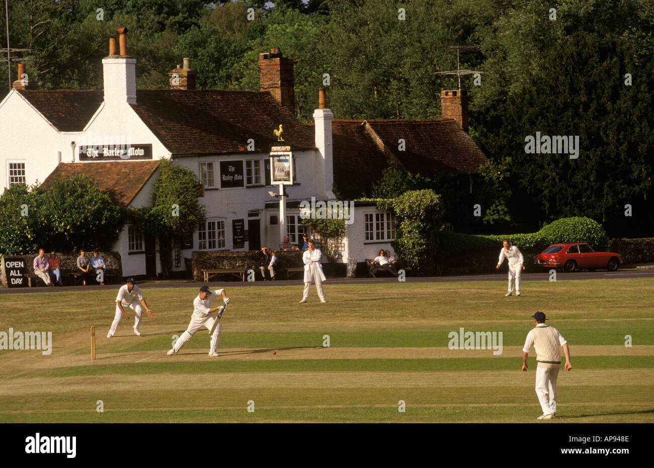 Village cricket at Tilford, Surrey. The Barley Mow the village local pub where there will be refreshments at the end of the game 1990s UK. HOMER SYKES Stock Photo