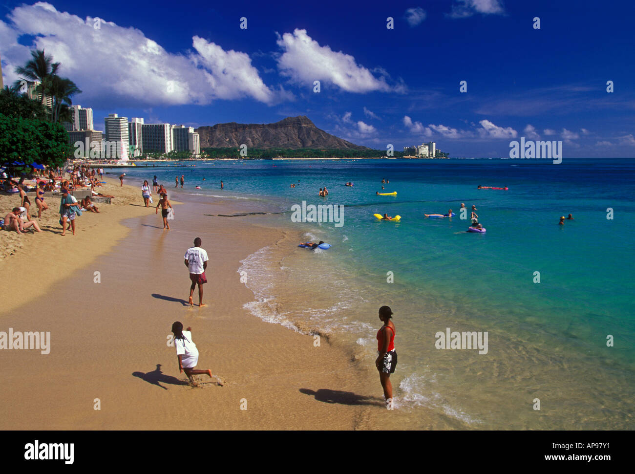 Bathers and hotels along Waikiki Beach with Diamond Head in the