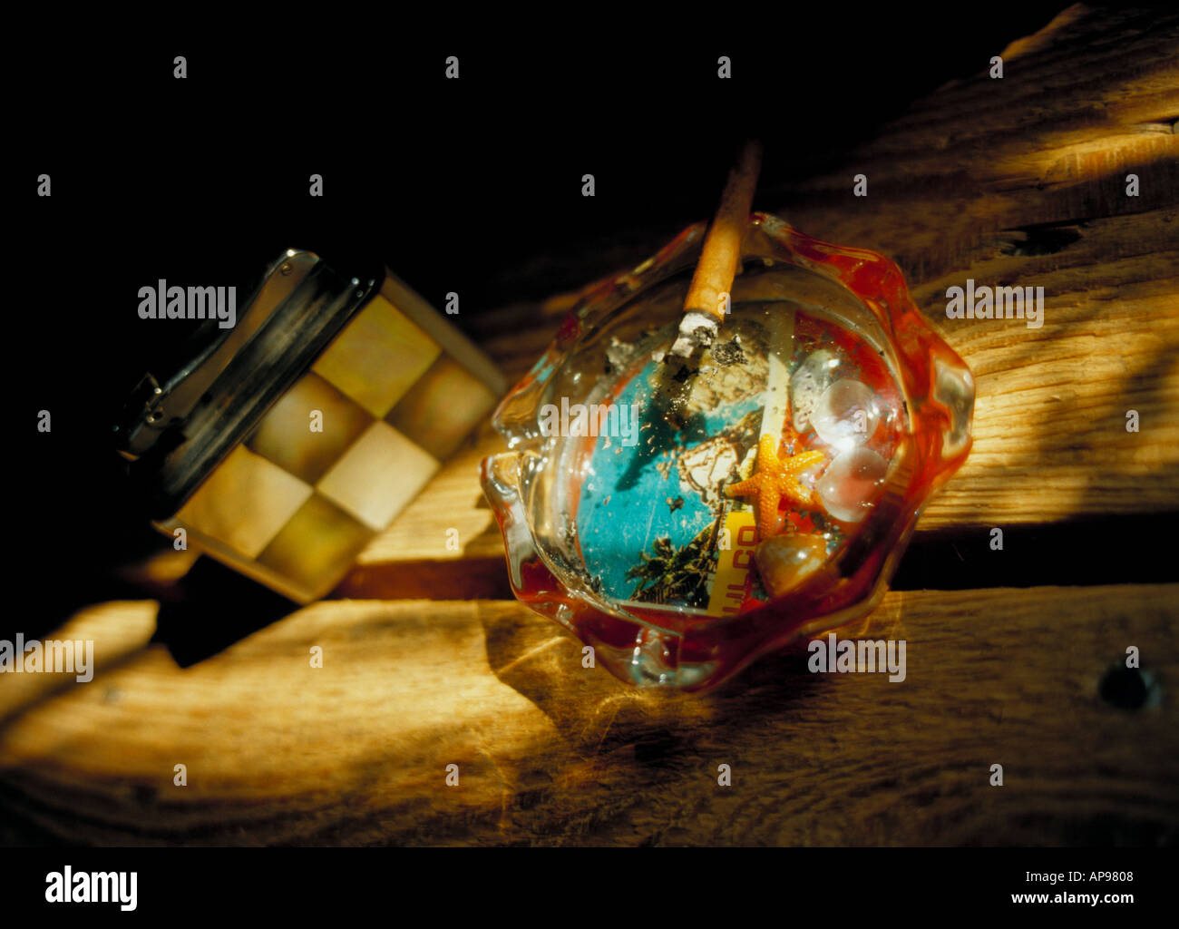 sunlit ashtray cigarette and cigarette lighter Stock Photo Alamy