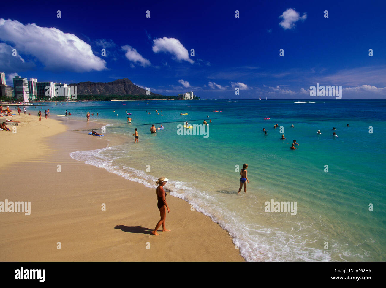 Bathers and hotels along Waikiki Beach with Diamond Head in the