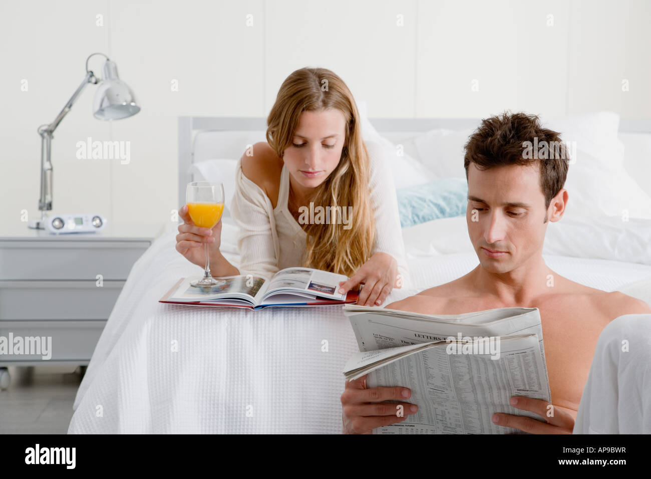 Couple reading in bedroom Stock Photo Alamy