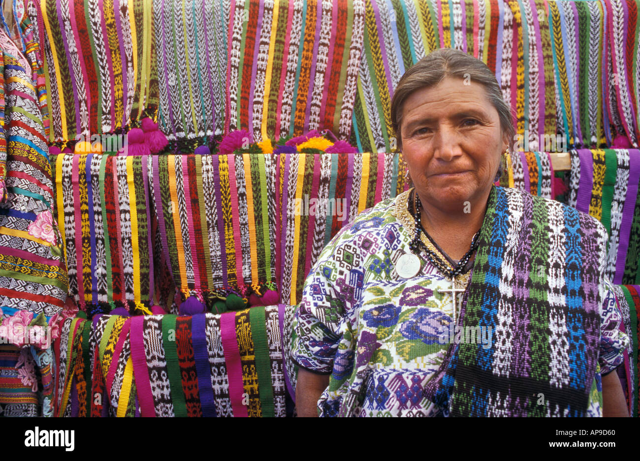 Selling ikat decorated shawls from Totonicapan Salcaja market nr Quezaltenango Guatemalan highlands Stock Photo