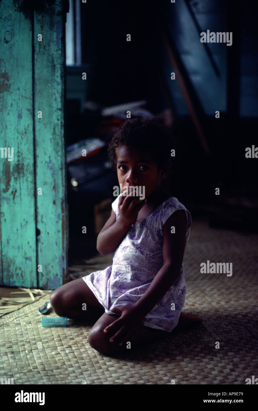 A small girl on Yanuya Island Fiji is studying a foreign visitor Stock Photo