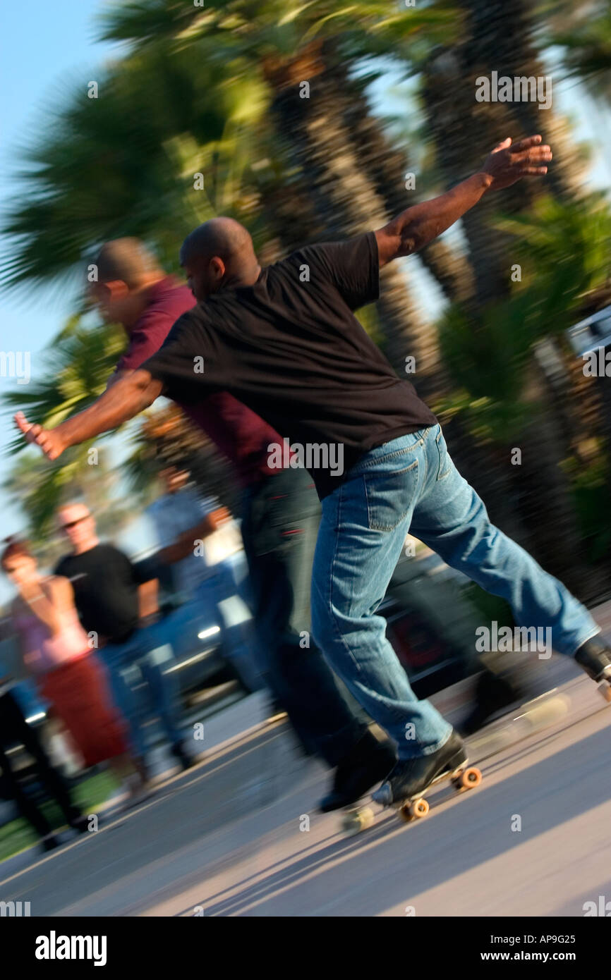 A high energy image of two men of color dancing on roller skates Stock