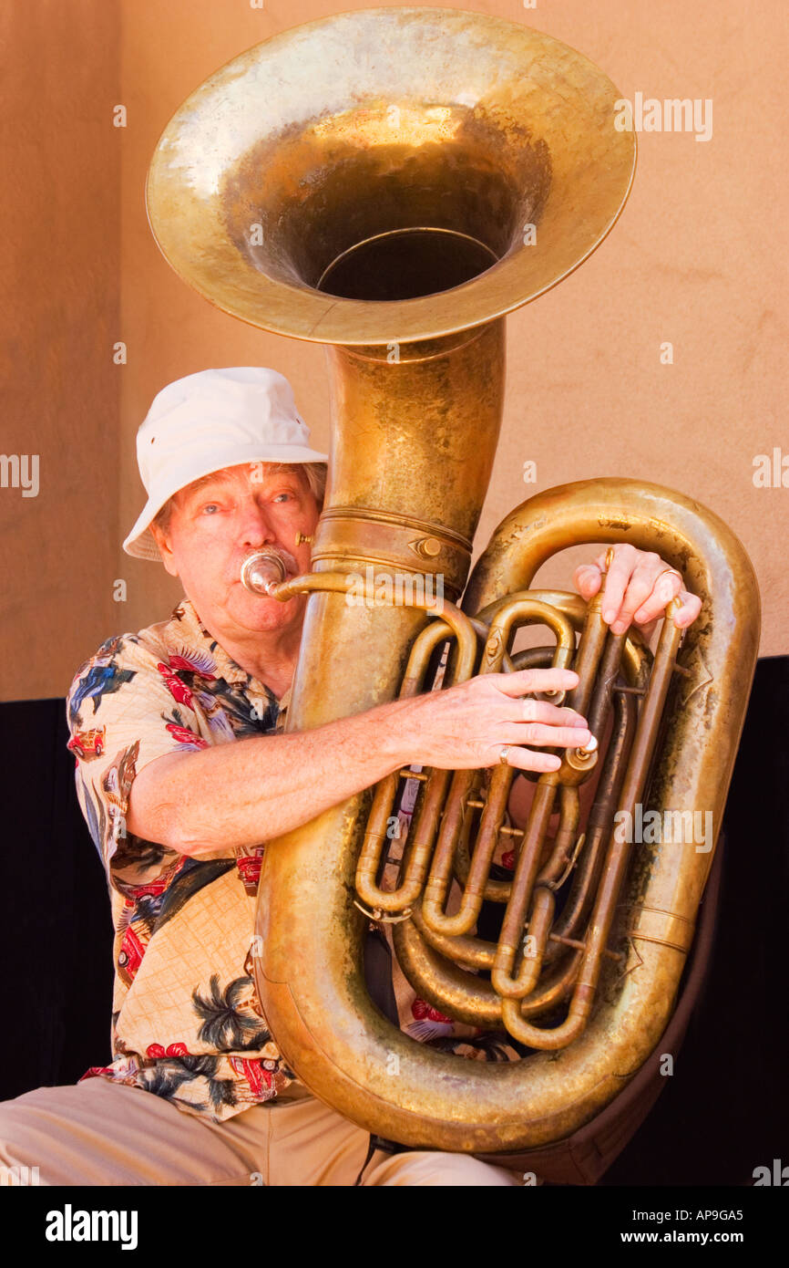 An active senior enjoys playing a tuba in a Dixieland jazz band Stock