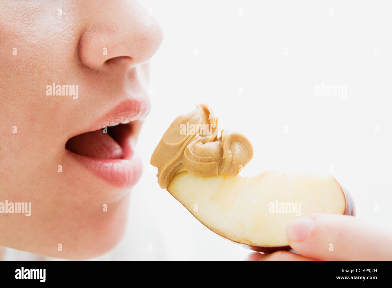 Woman eating apple and peanut butter Stock Photo Alamy