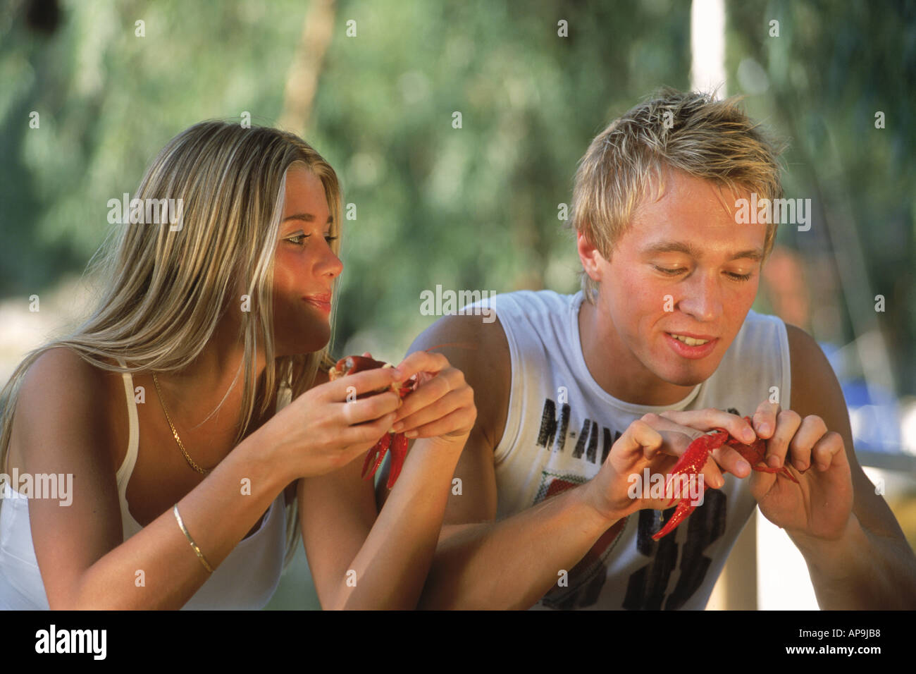 Young Swedish couple at traditional crayfish party in August Stock Photo
