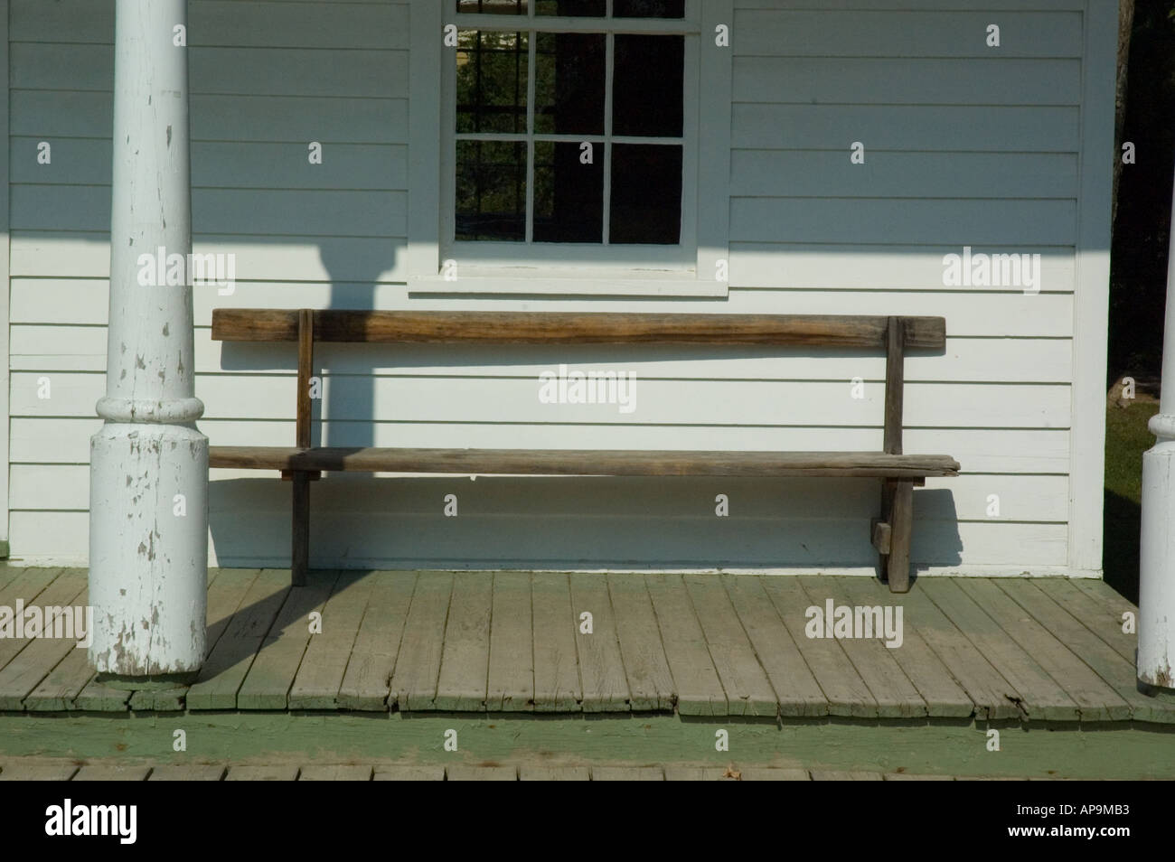 Old wooden bench sitting on front porch of town hall Stock Photo - Alamy