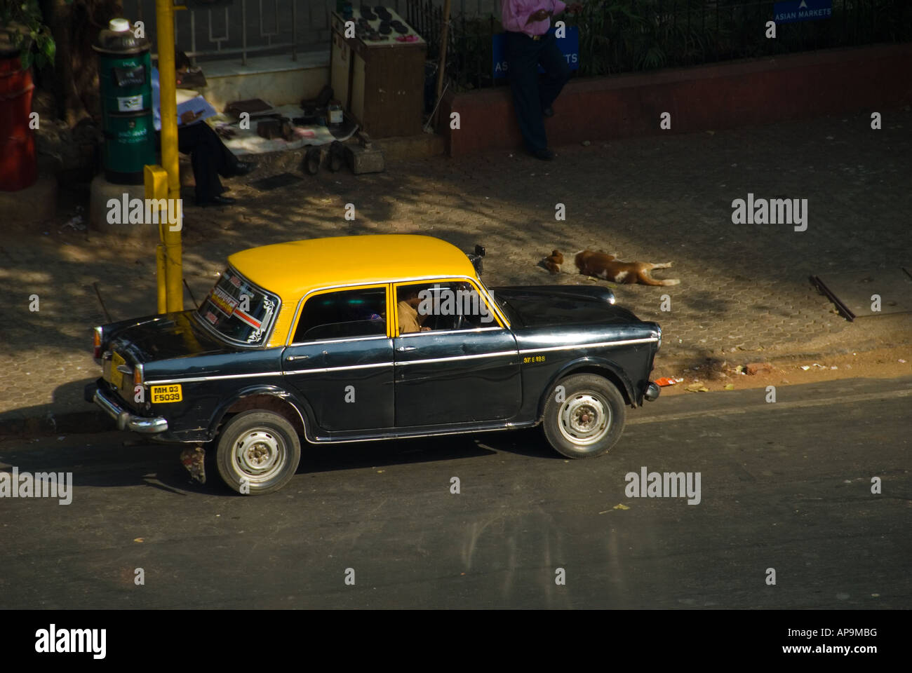 A Yellow and Black Taxi Cab in Mumbai India Stock Photo