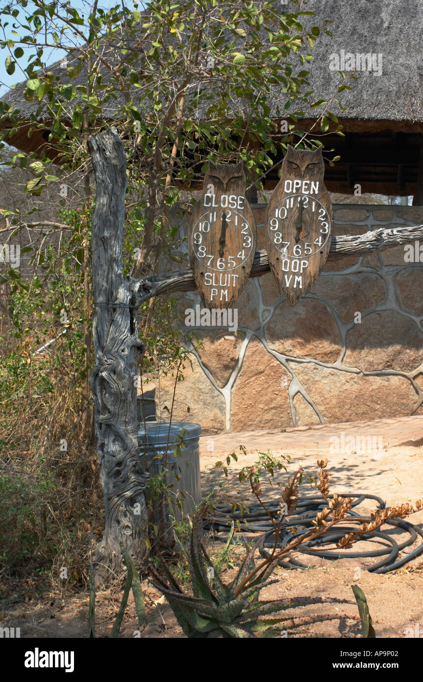 Owls showing park opening and closing times at exit at Skukuza and all