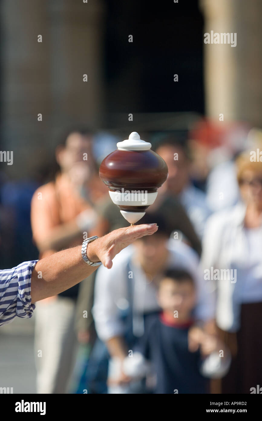 A spinning top balanced on the hand of an elderly gentleman Sunday market Plaza Nueva Bilbao Stock Photo