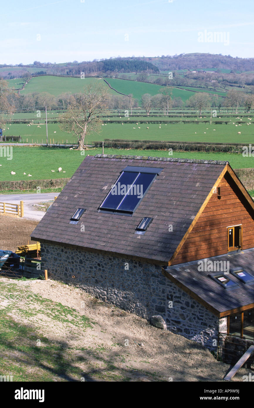 Solar water heating panels on a new barn conversion. Powys, Wales, UK. Stock Photo