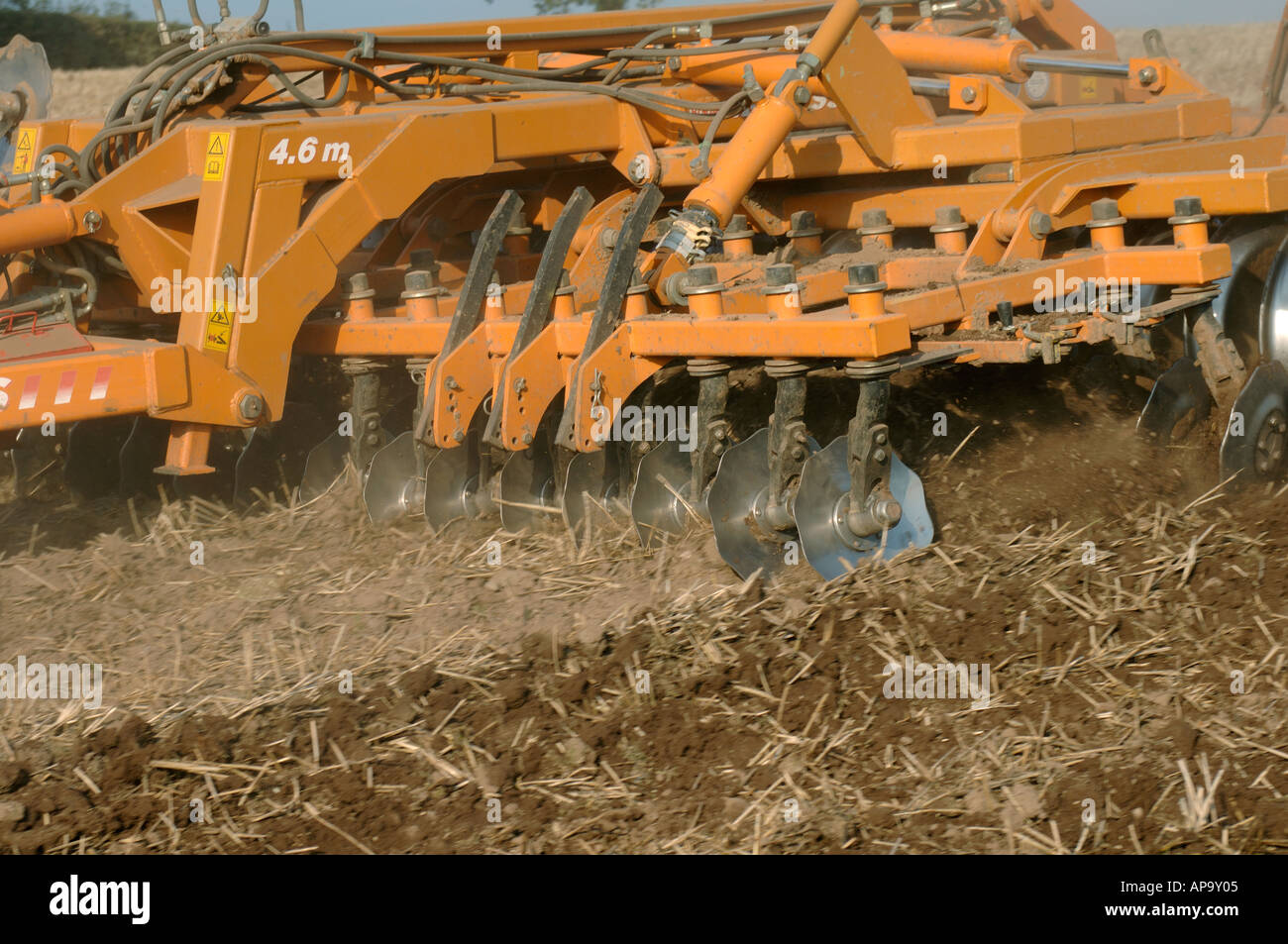 Close up of power disc harrowing subsoiled stubble field before planting to barley Stock Photo