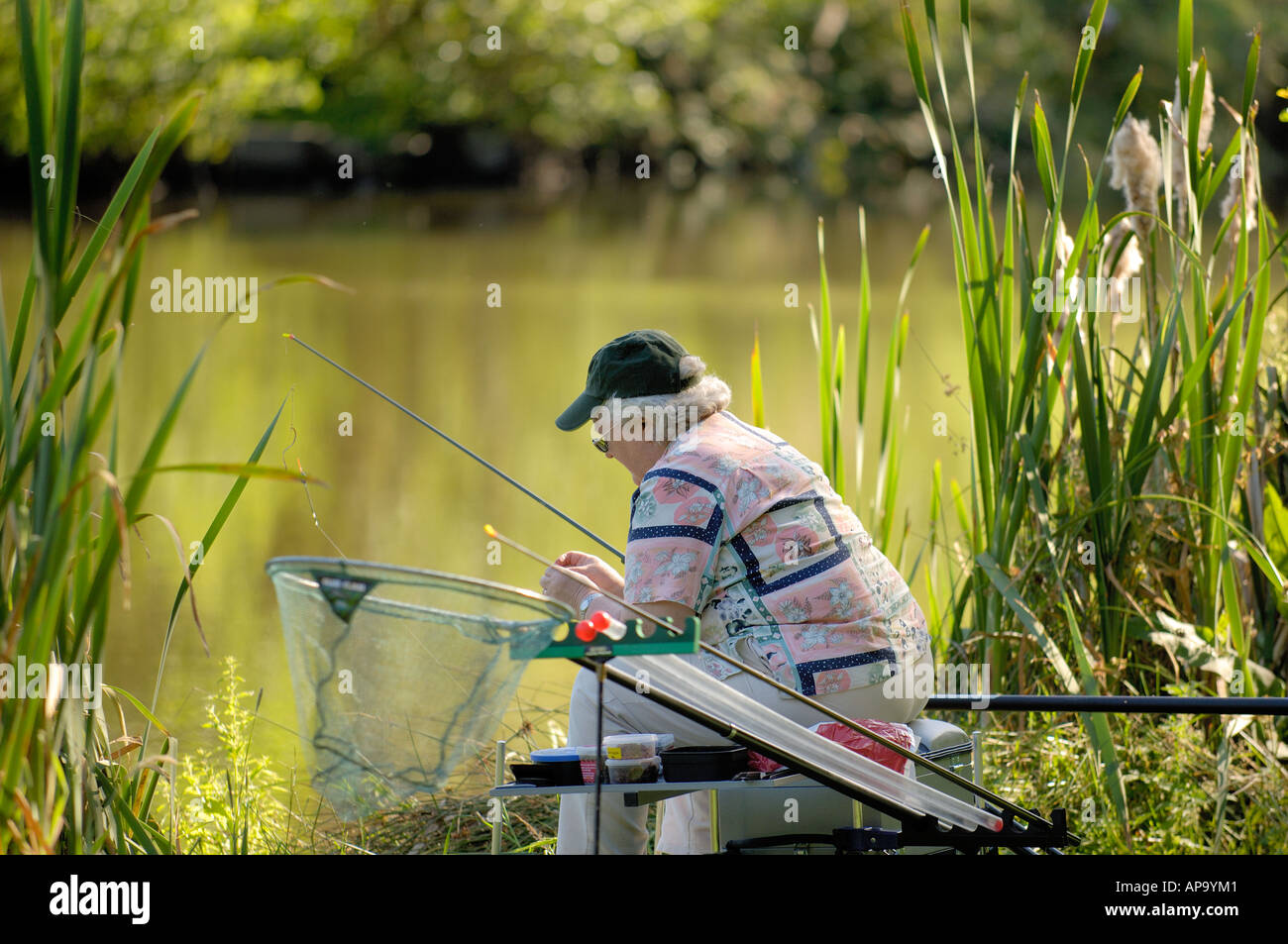 https://c8.alamy.com/comp/AP9YM1/woman-coarse-fishing-with-pole-moel-y-garth-pools-guilsfield-near-AP9YM1.jpg