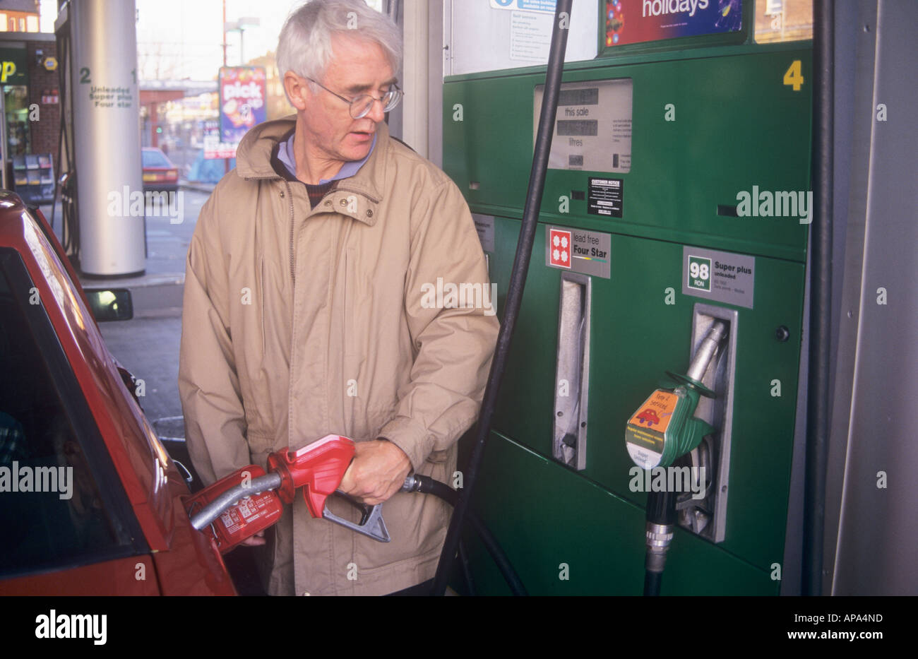 Man filling leaded petrol, UK Stock Photo