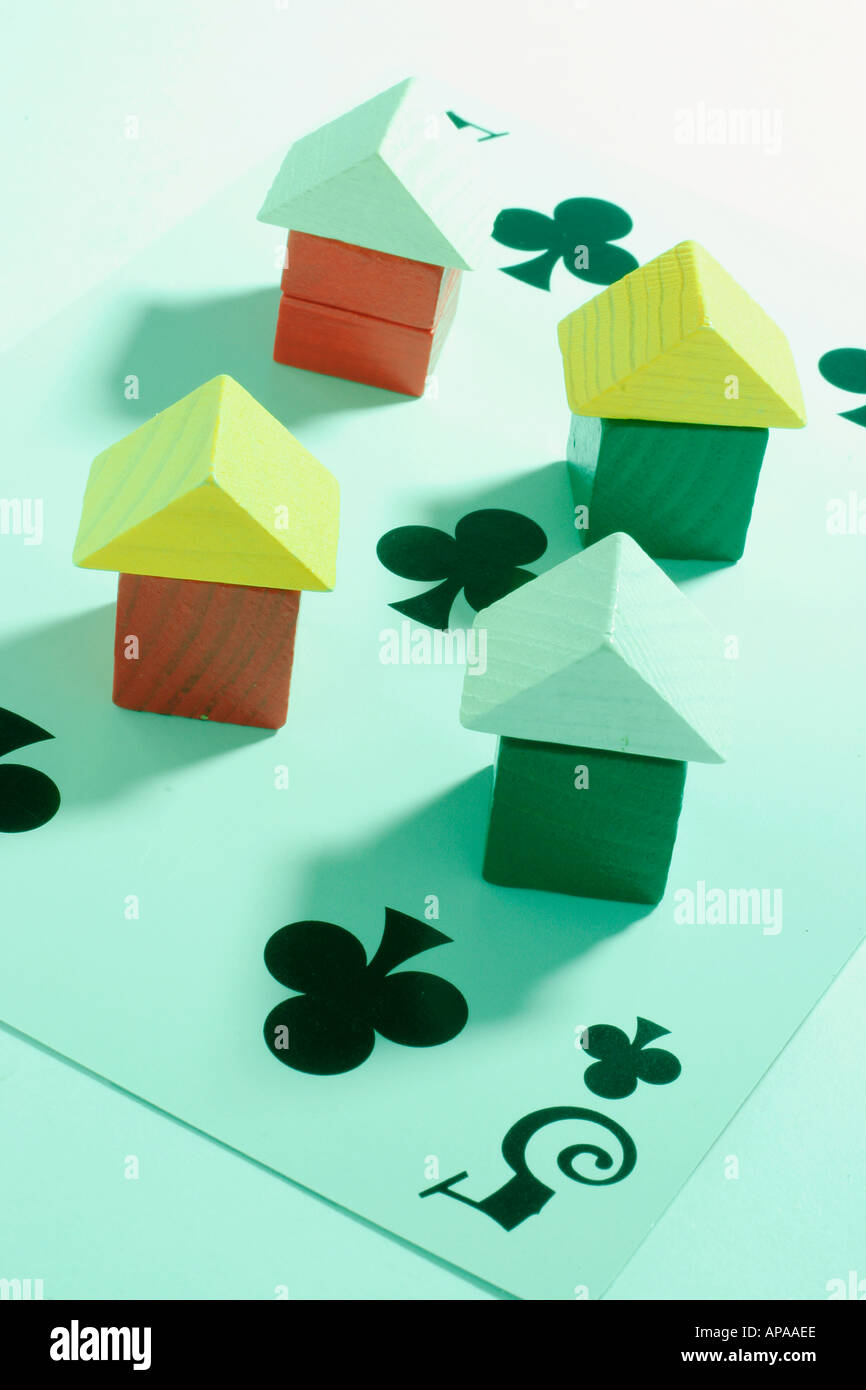 Wooden Miniature Houses on Playing Card Stock Photo