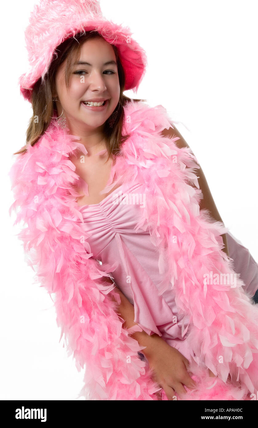 Caucasian teen girl wearing pink hat and pink boa hires stock
