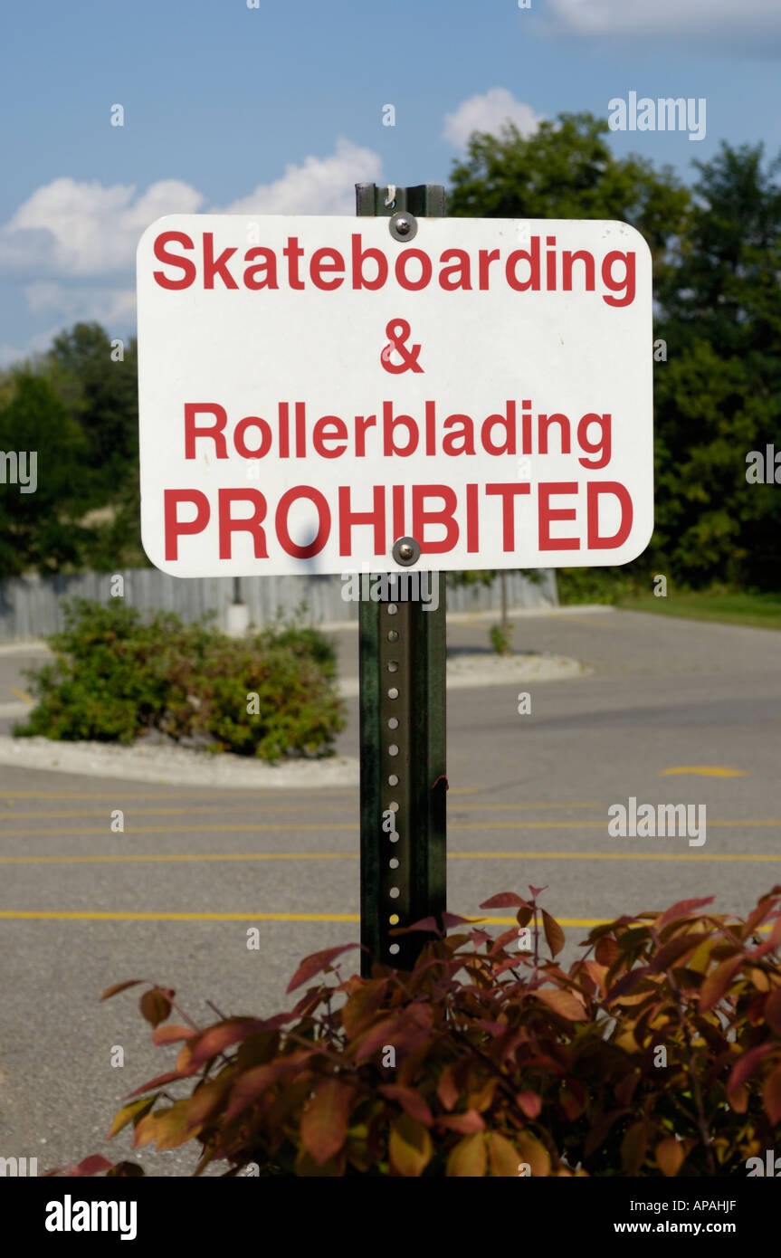 skateboarding and rollerblading prohibited sign in a parking lot Stock