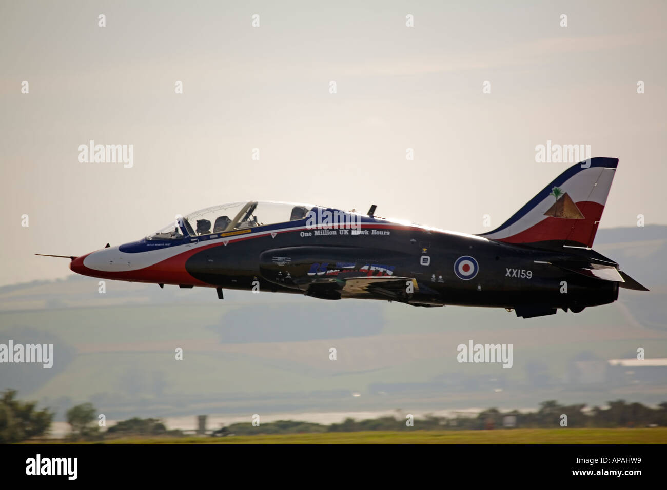 Hawk T1 RAF jet trainer low pass over airfield runway - colour scheme marks 85th Anniversary of No 4 Flying Training School Stock Photo