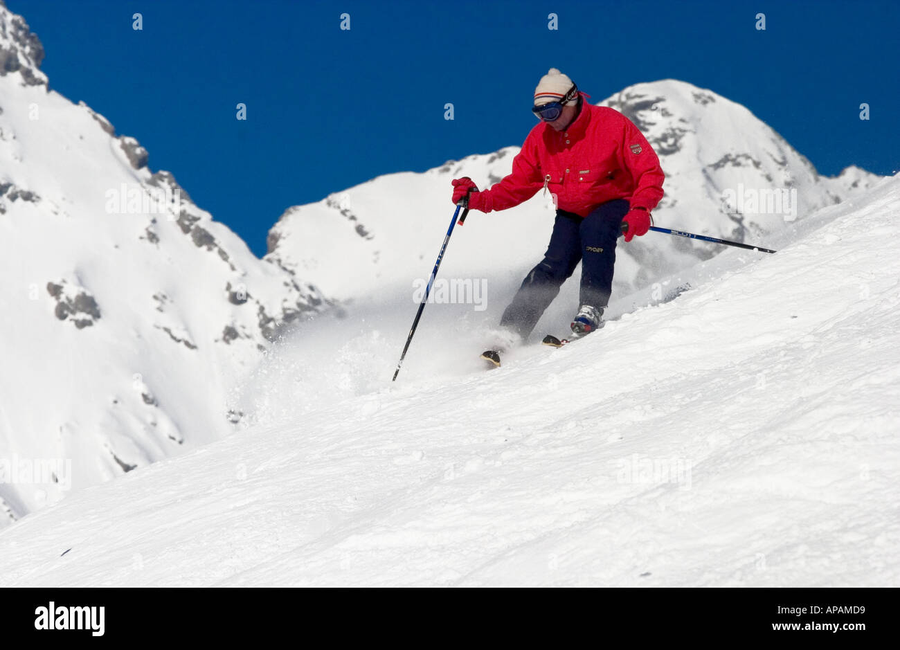 man enjoying the powder snow through on a winter day in grand bornand France Stock Photo