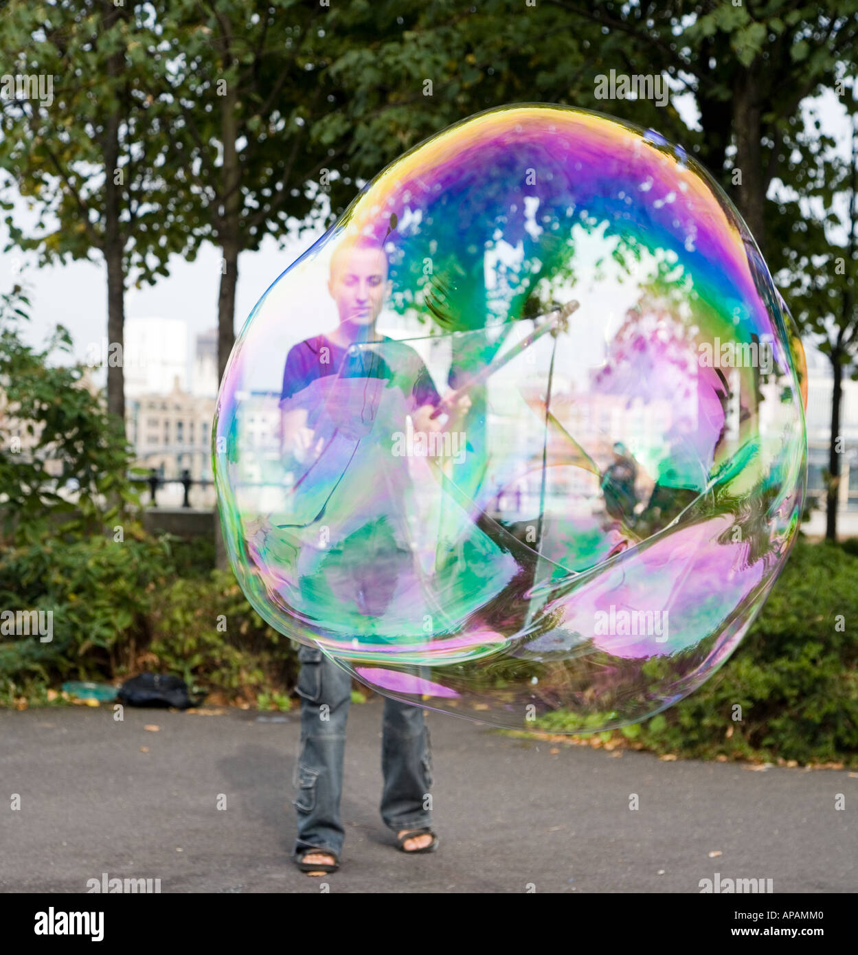 Woman Blowing Giant Bubbles The South Bank London UK Stock Photo